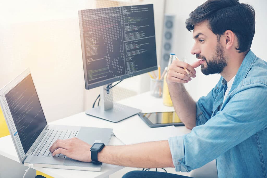 image of young ambitious man working in an office as programmer