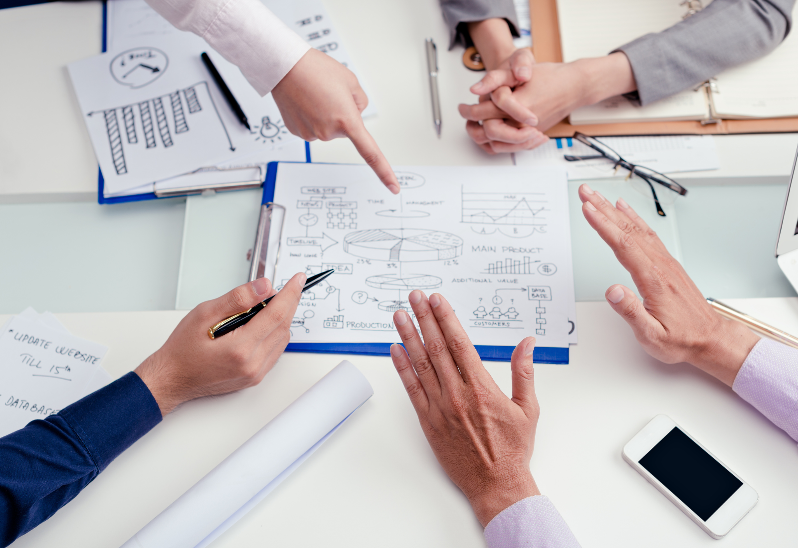 Image of people's hands over a document during collaboration