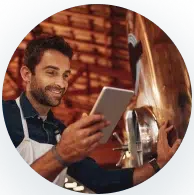 Man Smiles at His Tablet Screen, Suggesting a Breakthrough, Positive Results, or Communication
