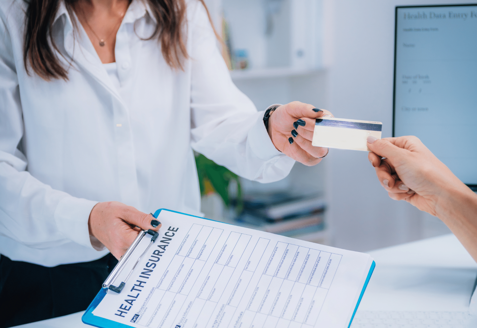 Image of a person handing their insurance card to another person