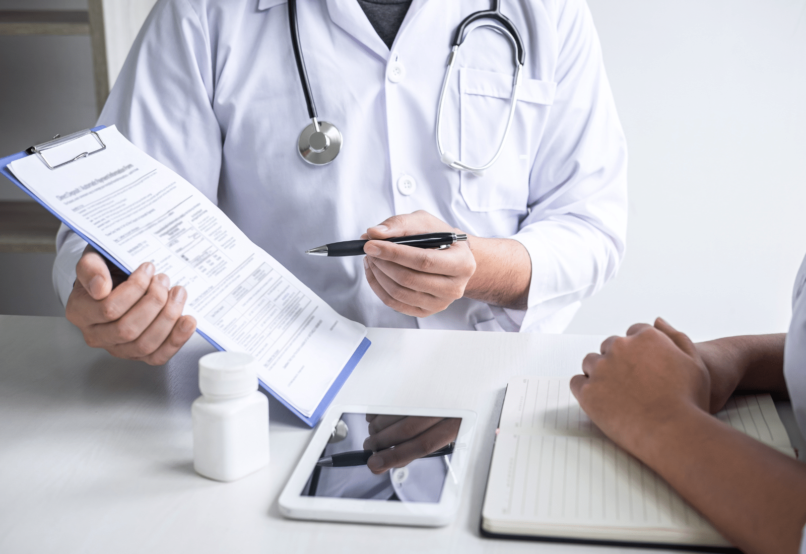 Image of a medical professional showing a document to a patient