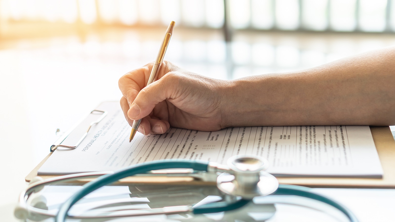 Image of a doctor writing discharge forms