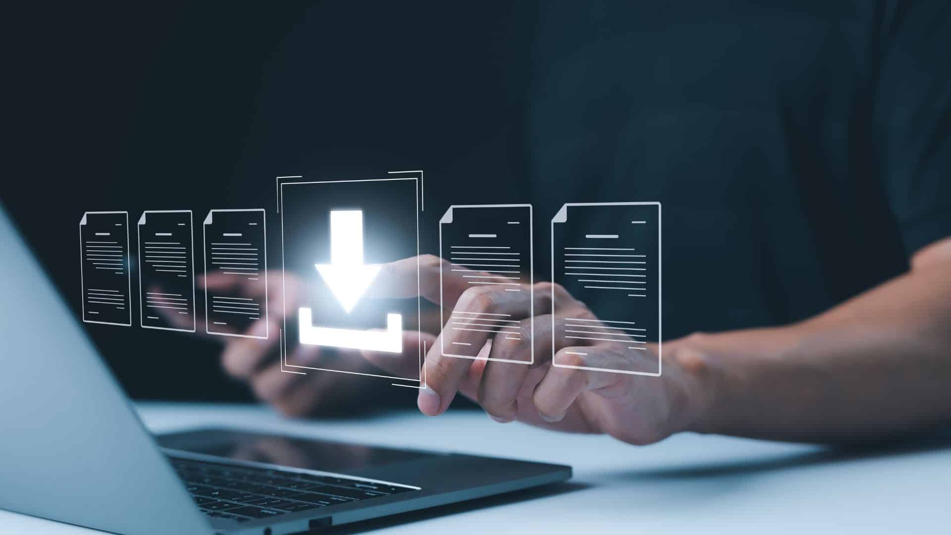 The image depicts a hand interacting with a holographic interface above a laptop, featuring a download icon and document icons, symbolizing cloud fax technology.