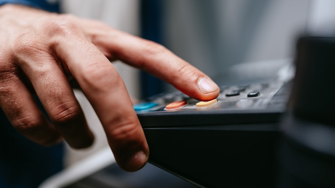 How to connect fax to EHR showing healthcare worker using fax machine for electronic health record integration