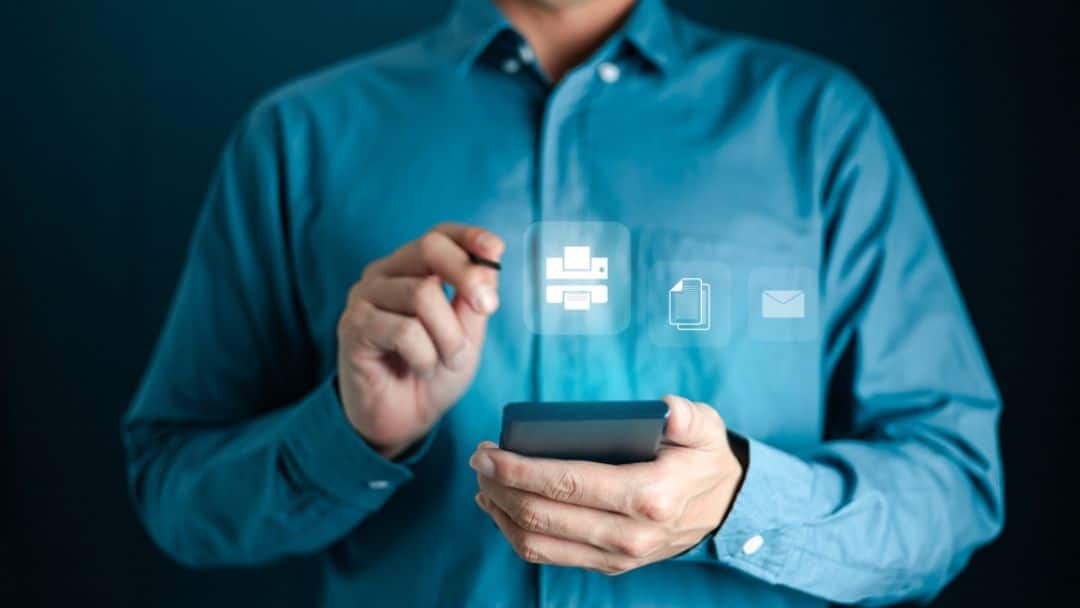 Professional holding mobile device with holographic fax, document, and email icons, illustrating modern secure faxing alternatives to eFax providing digital communication solutions in 2026.